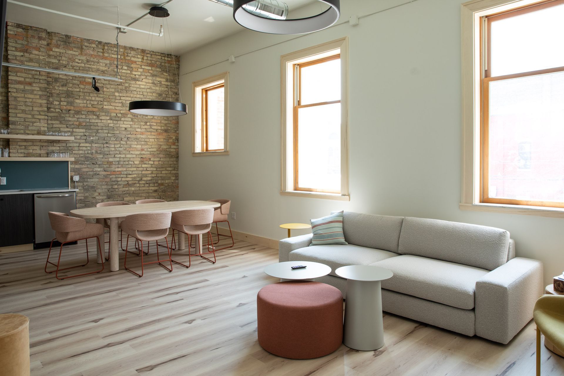 A living room with a couch , table and chairs.
