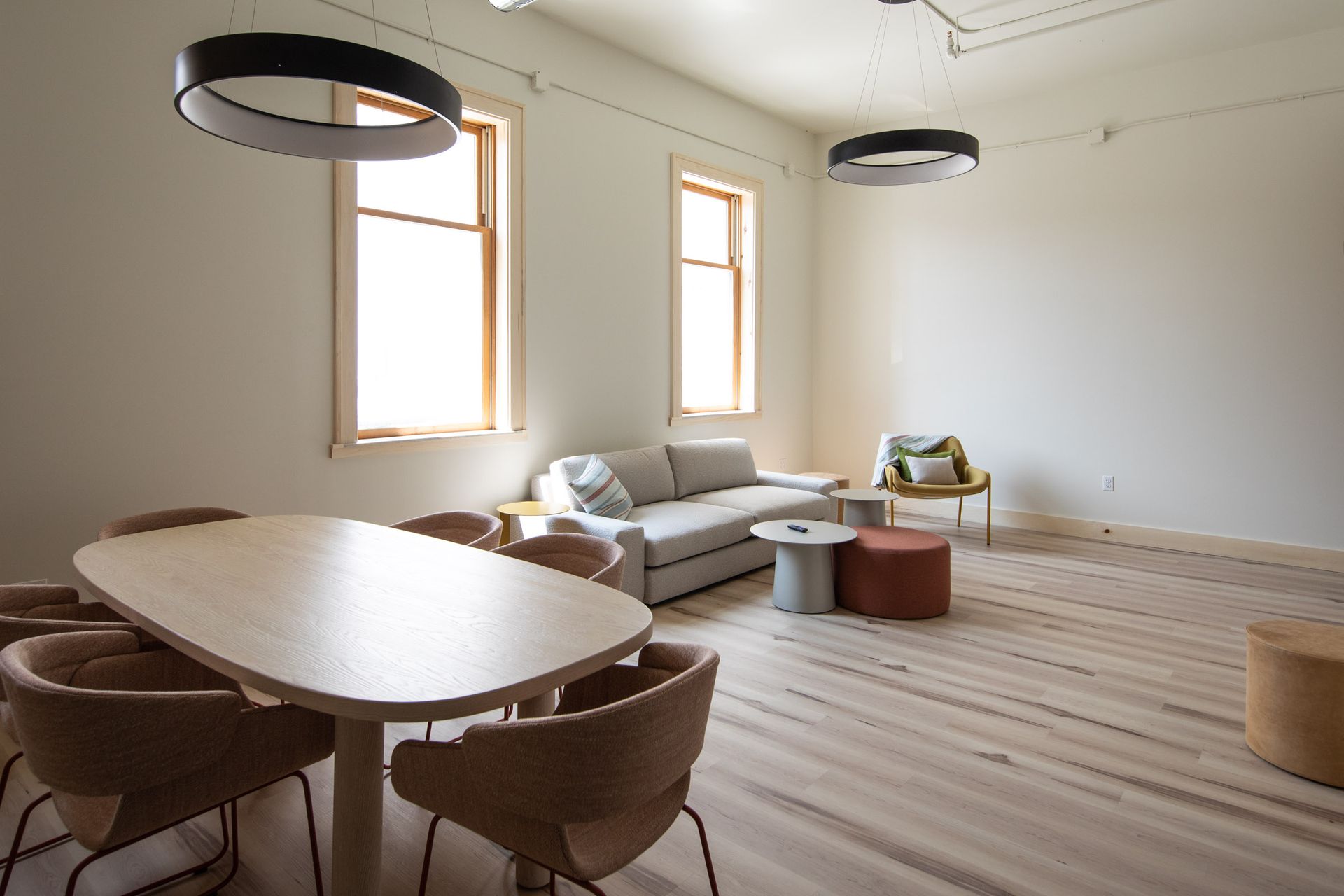 A living room with a table and chairs and a couch.