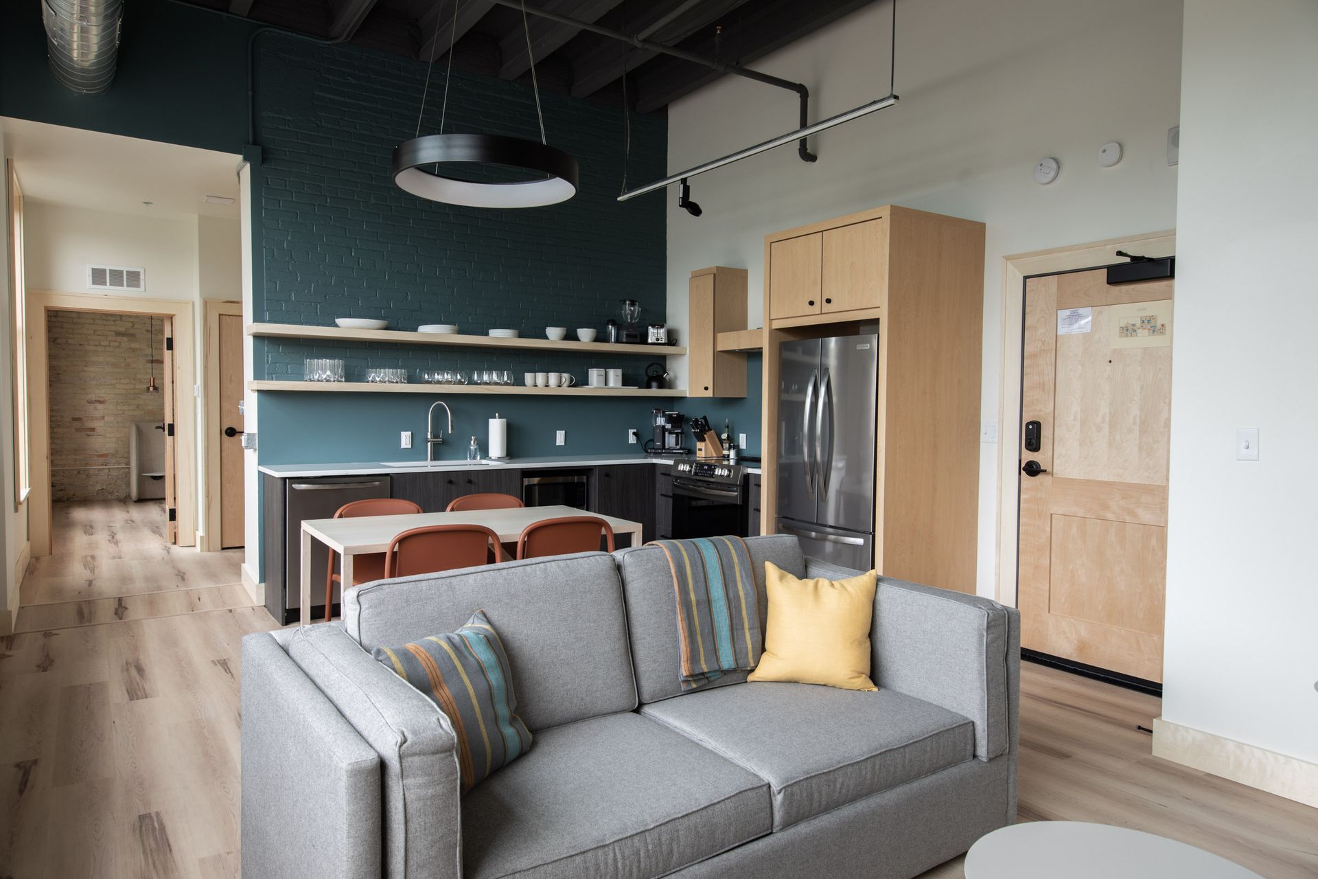 A living room with a couch and a kitchen in the background