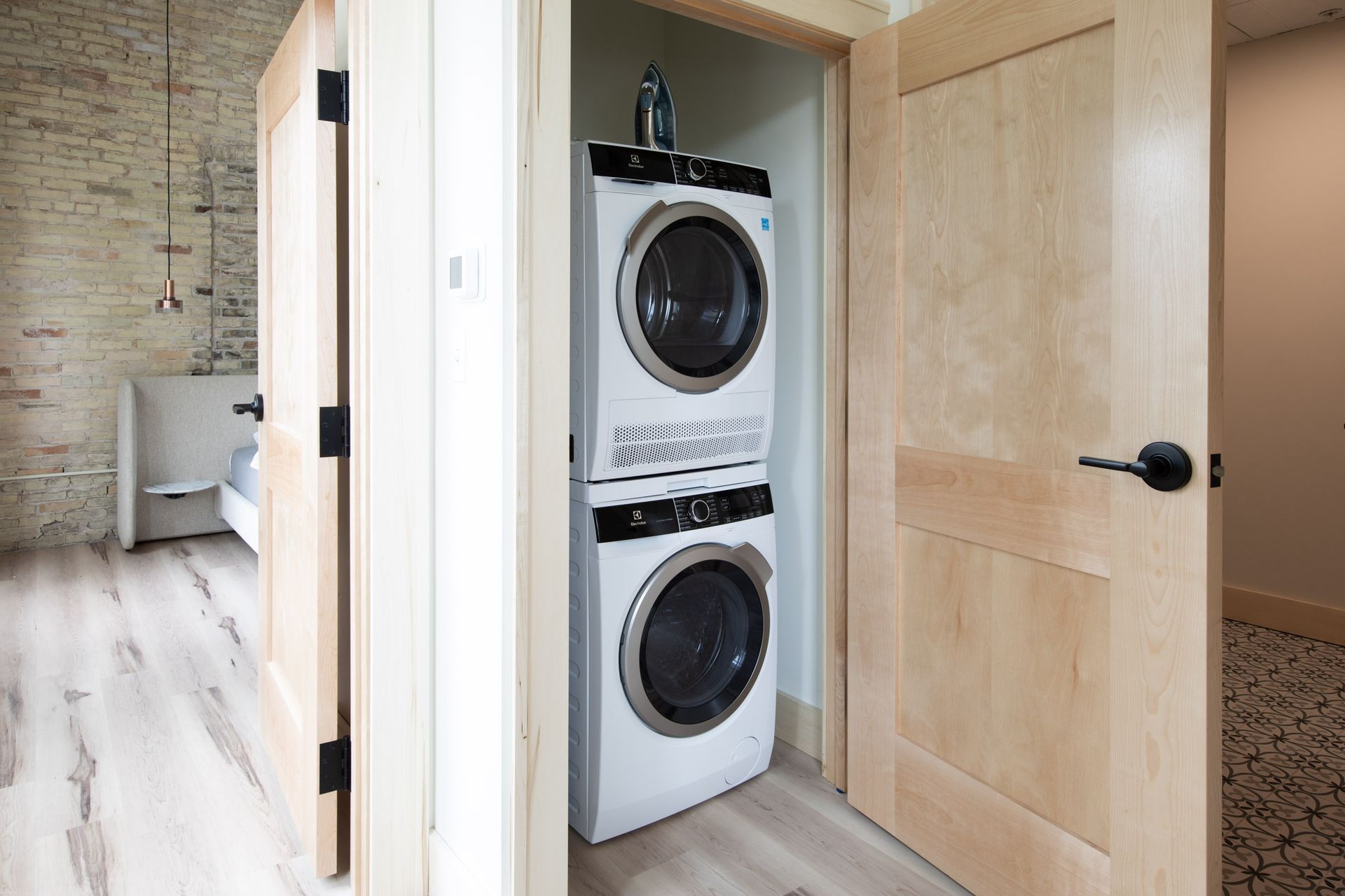 A washer and dryer are stacked on top of each other in a laundry room.