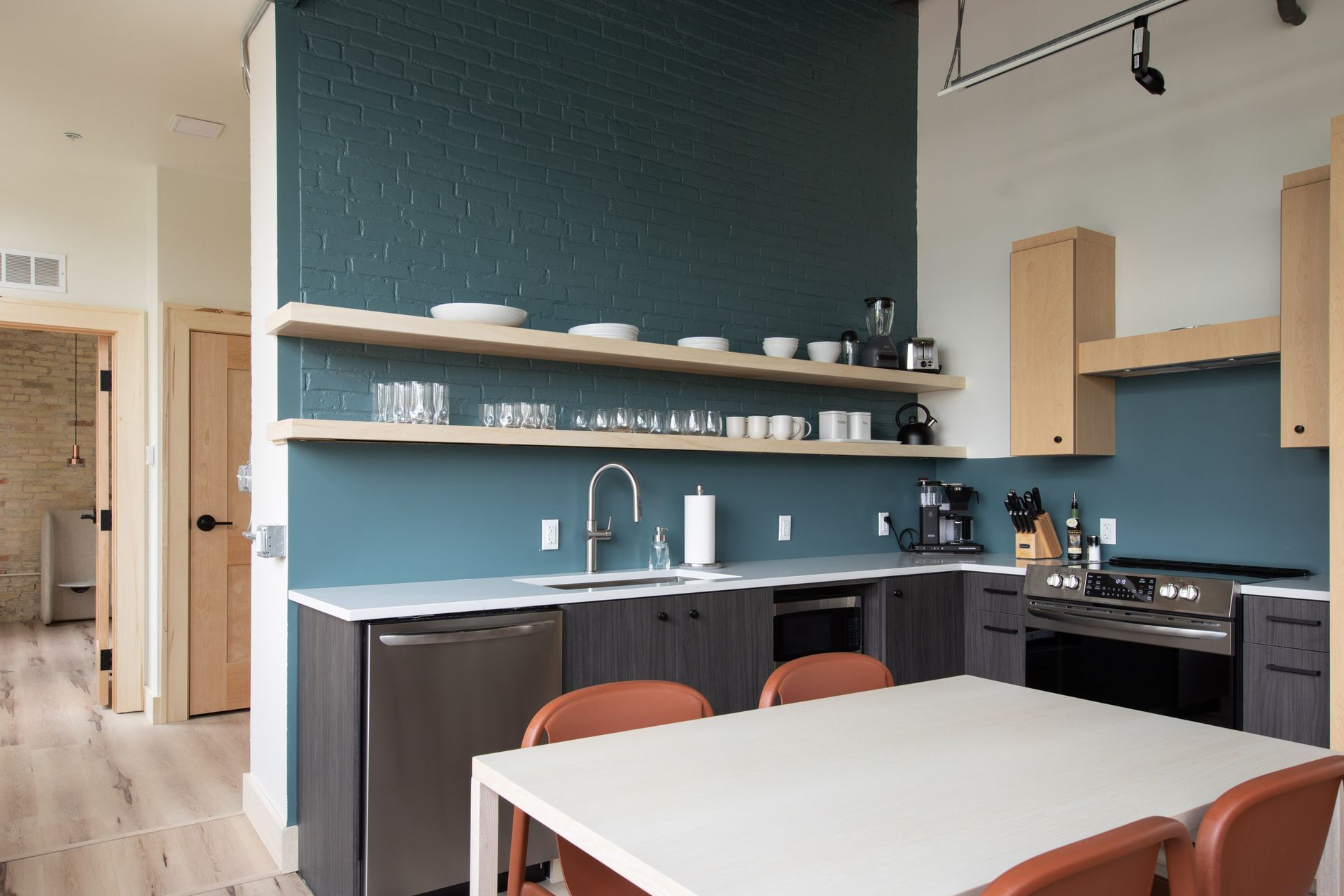 A kitchen with a table and chairs in it