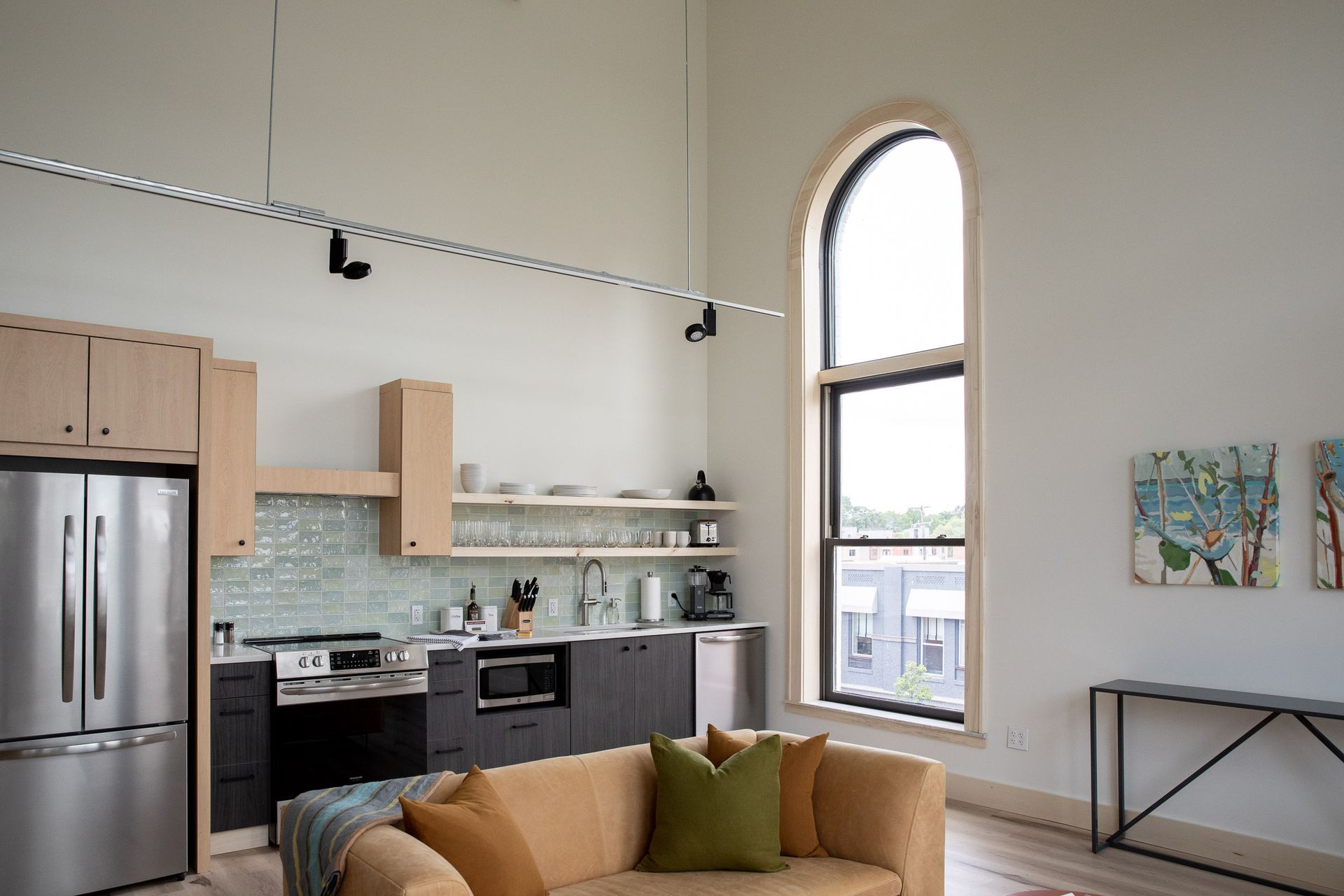 A living room with a couch and a kitchen in the background