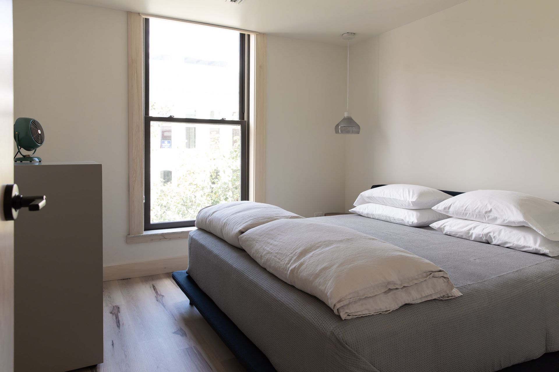 A bedroom with a large bed and a window