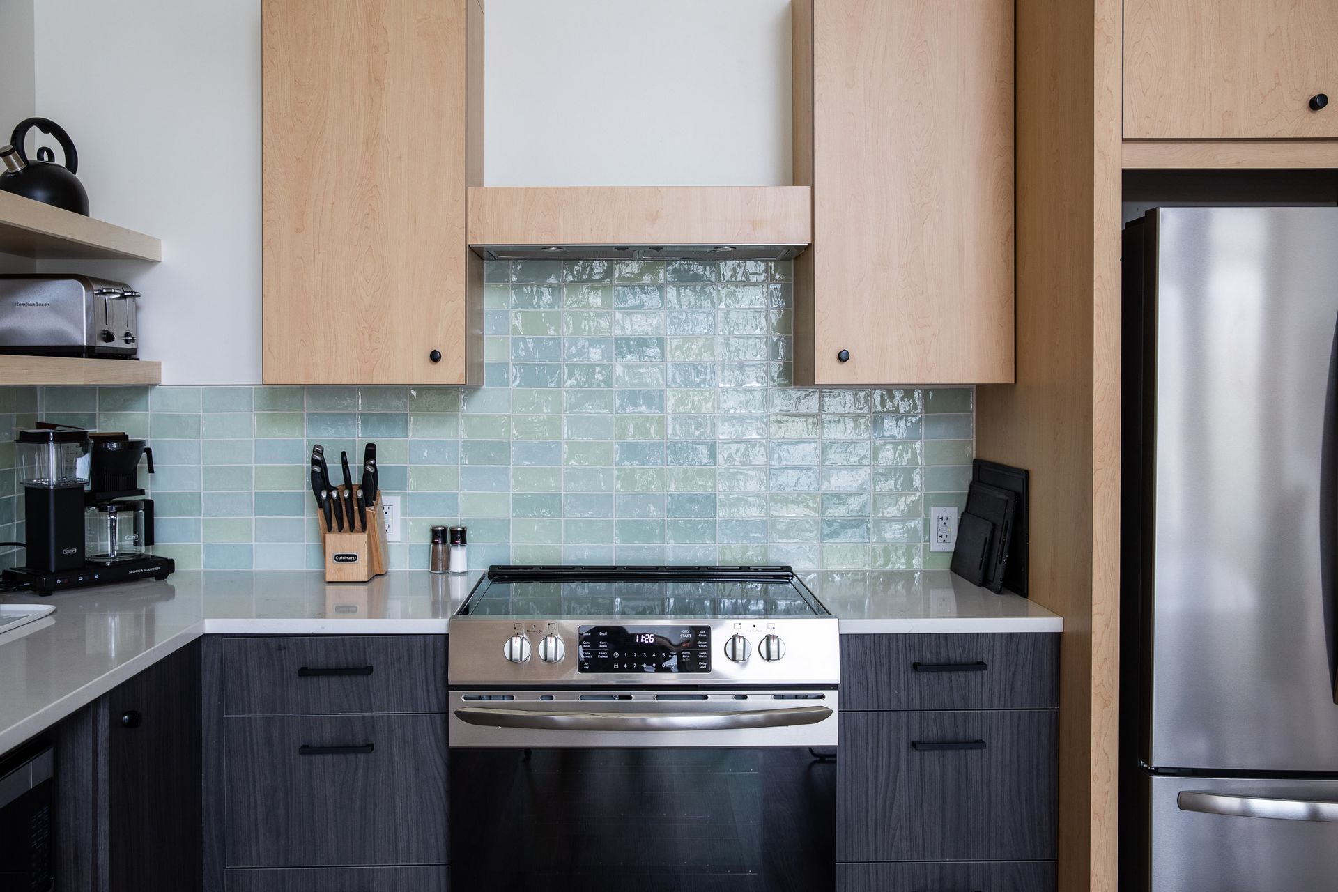 A kitchen with stainless steel appliances and wooden cabinets.