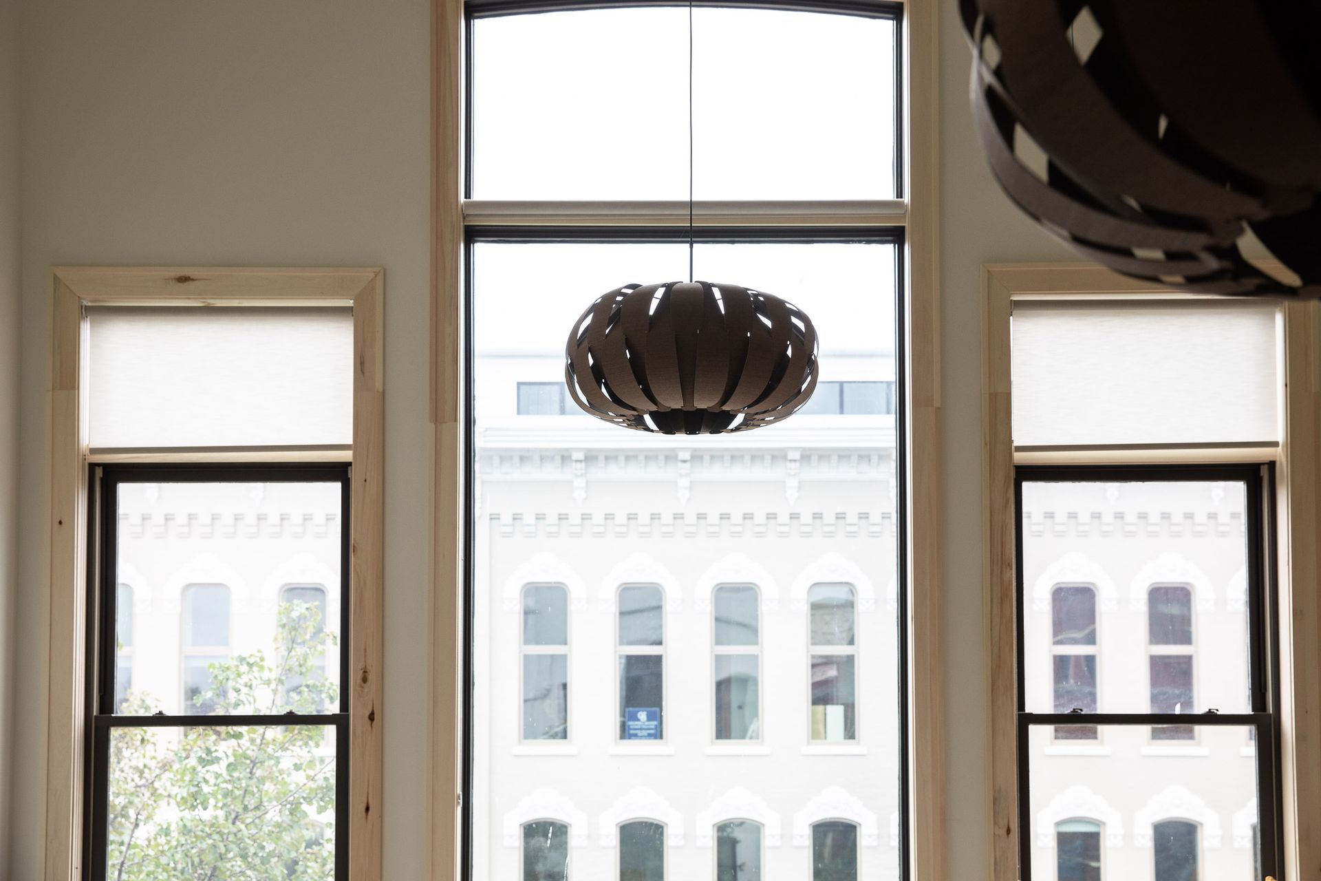 A room with a lot of windows and a chandelier hanging from the ceiling