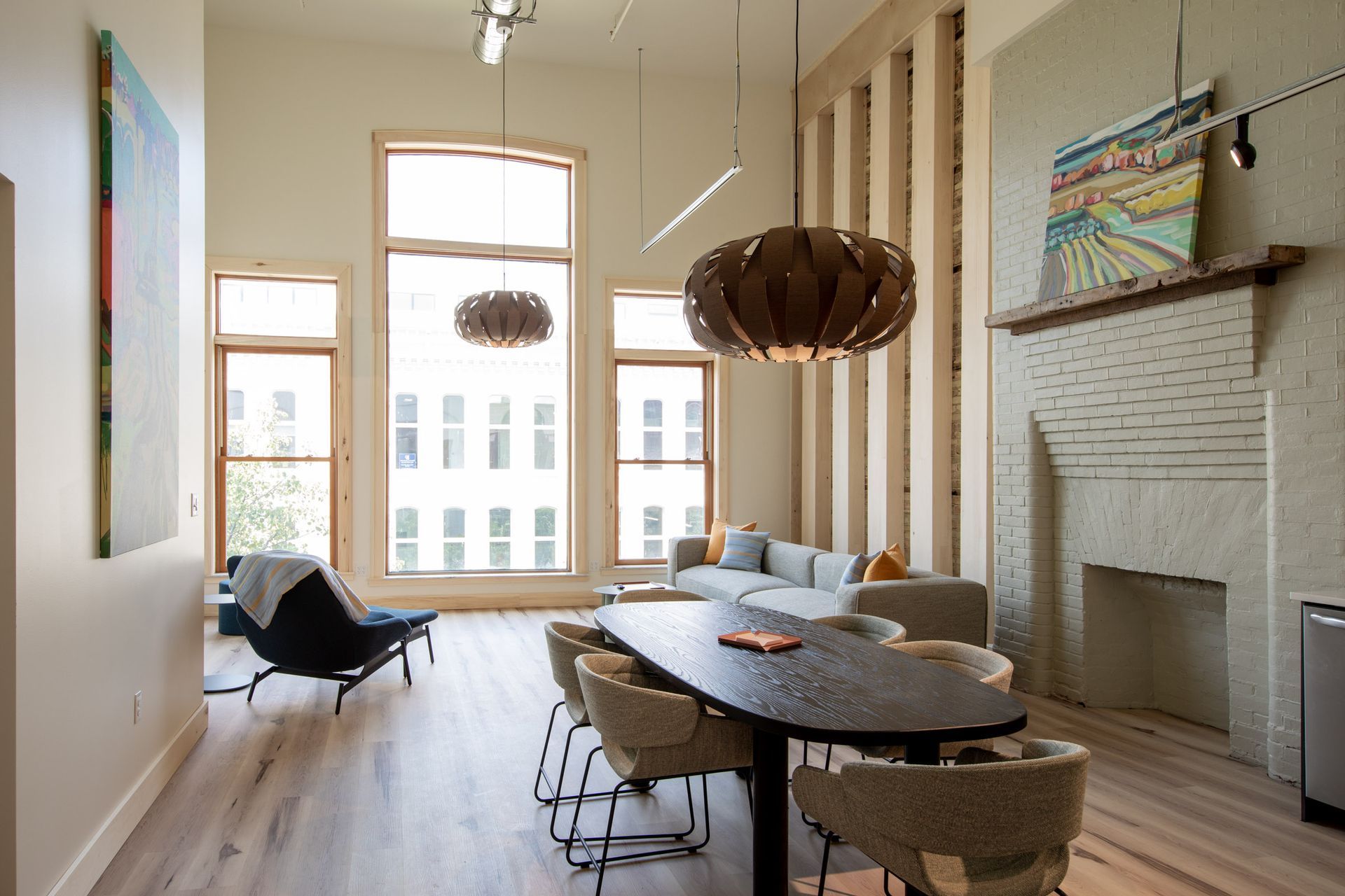 A living room with a table and chairs and a fireplace