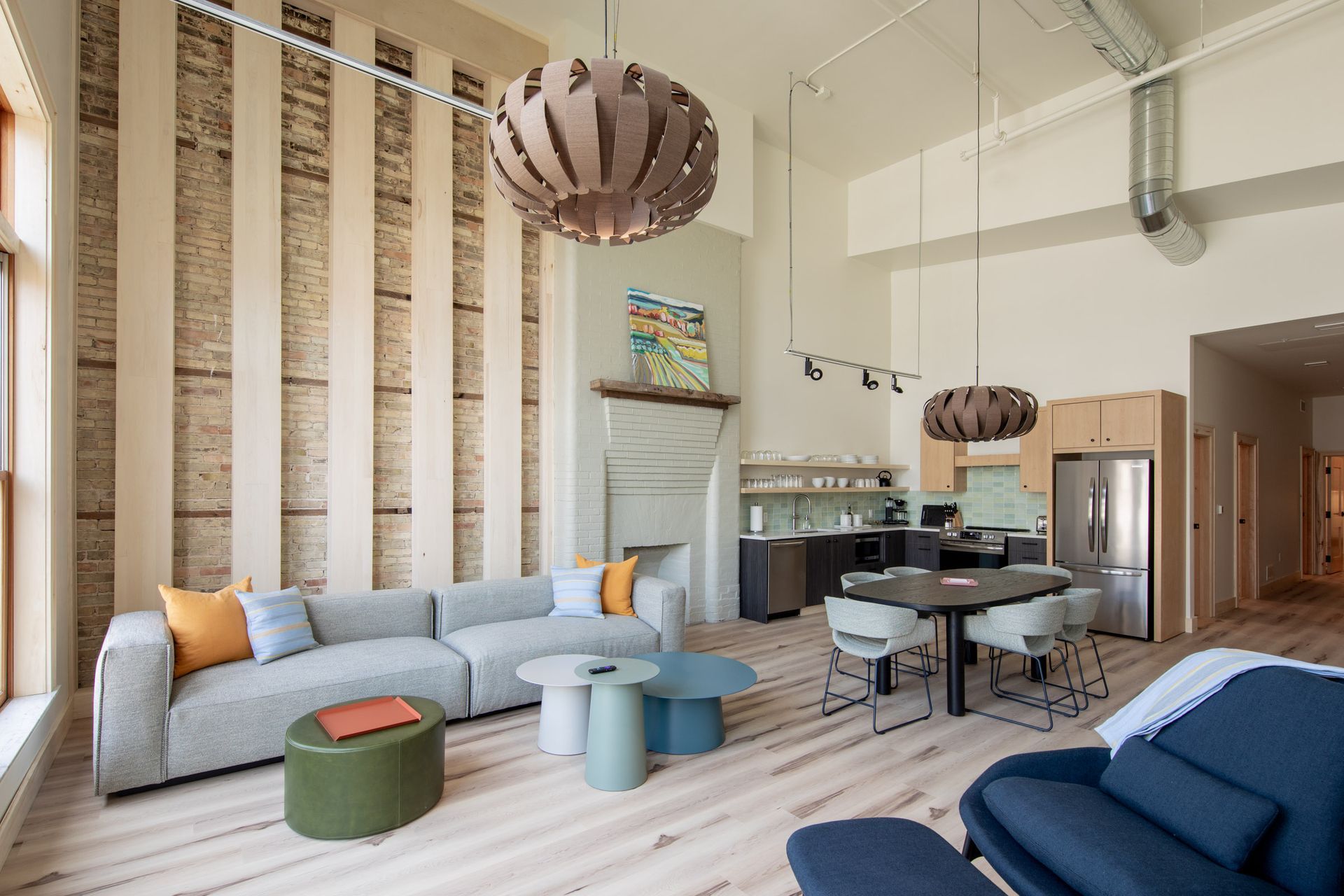 A living room with a couch , chair , ottoman and table