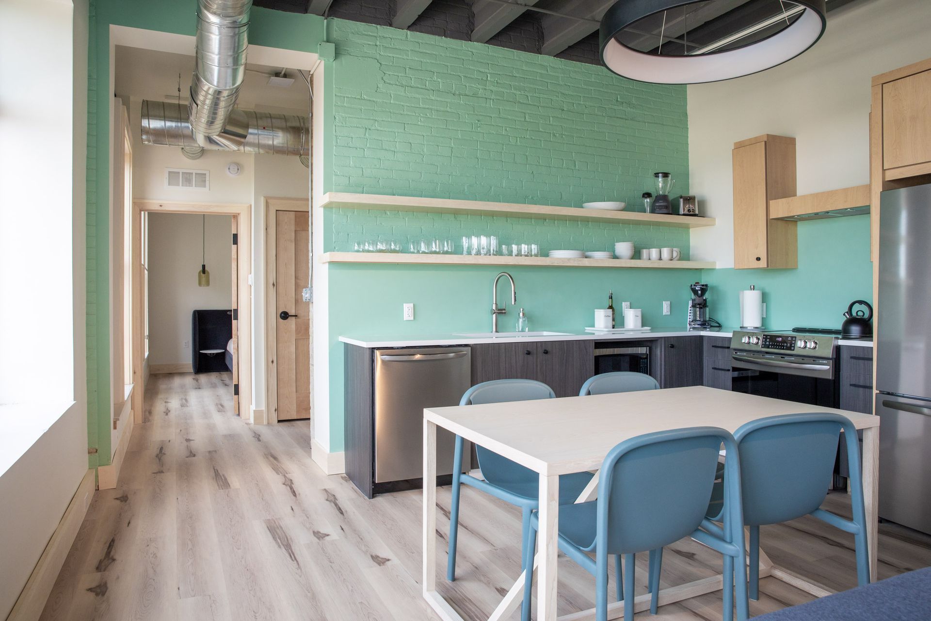 A kitchen with a table and chairs in it
