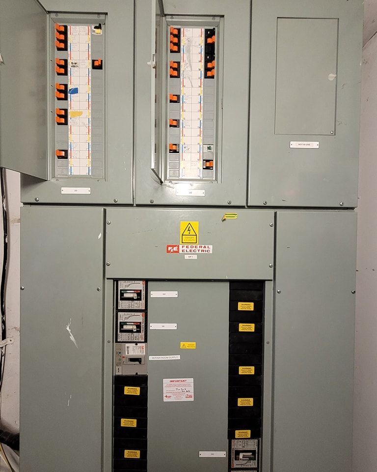 A man wearing yellow gloves is holding a coil of wire.