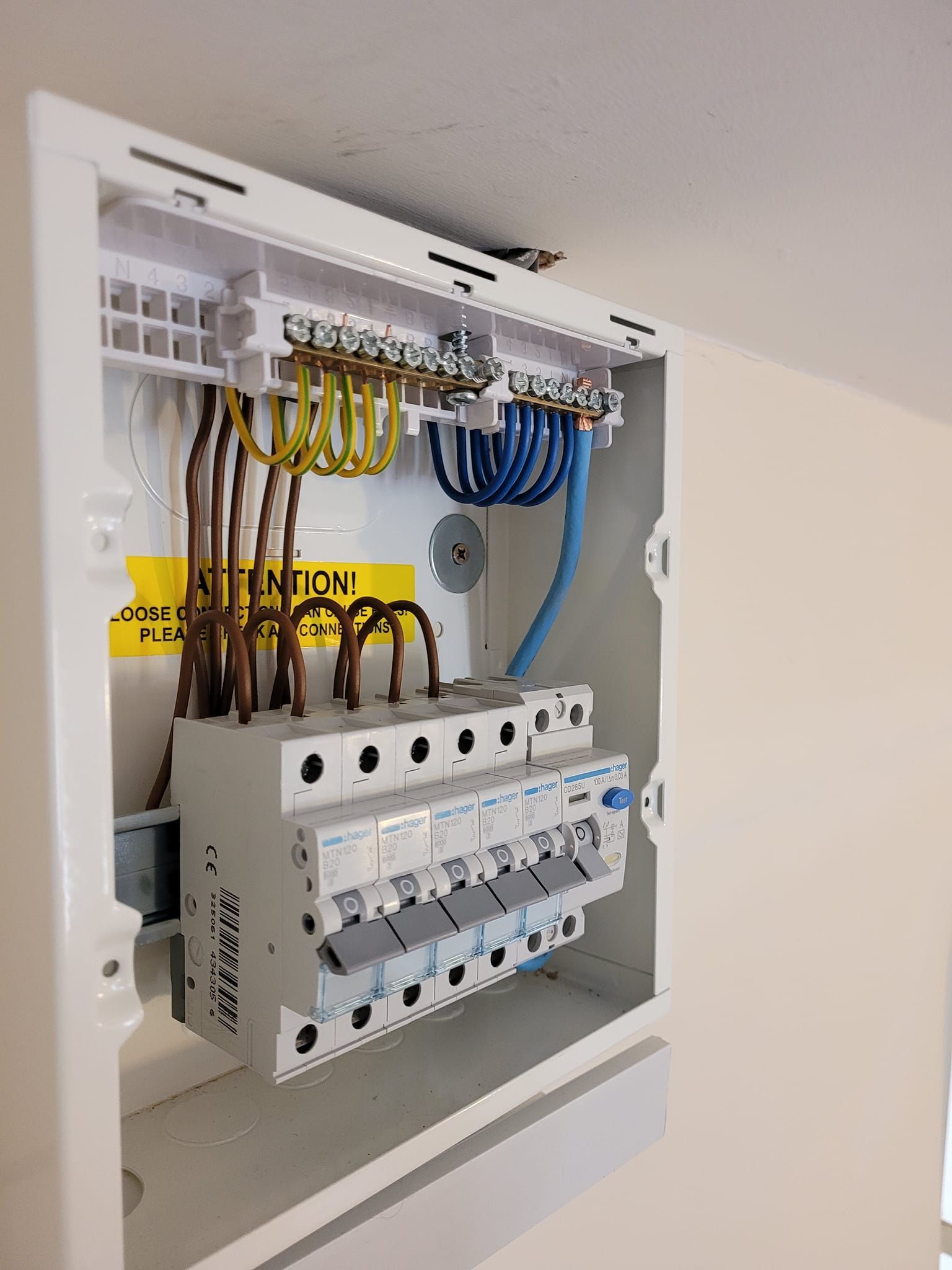 A yellow multimeter is sitting on top of a blueprint.