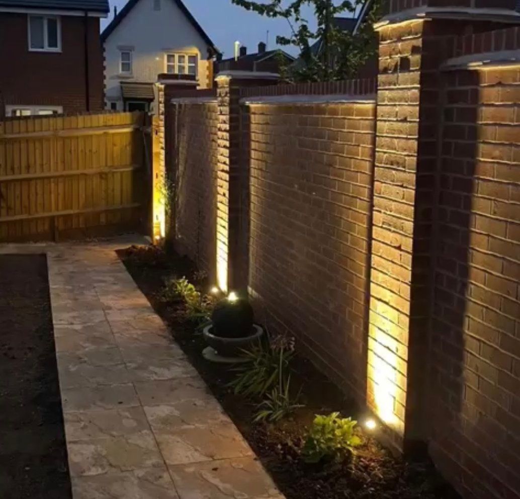 A brick wall with lights on the side of it