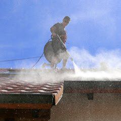 Power washer on the roof washing with machine