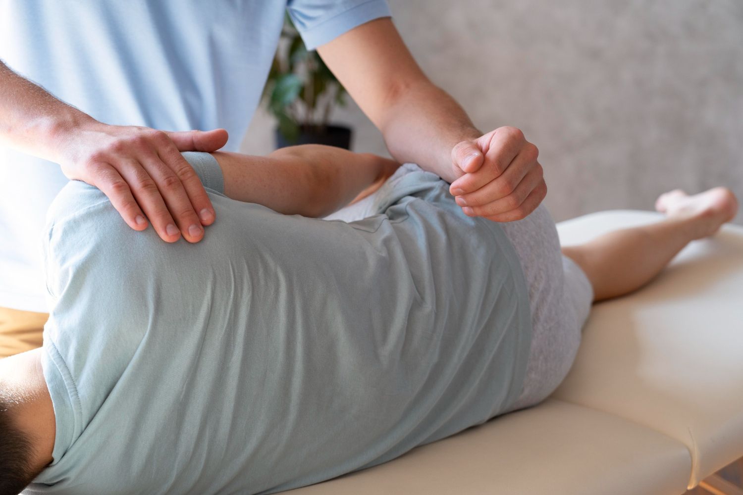A person is laying on a table getting a massage.