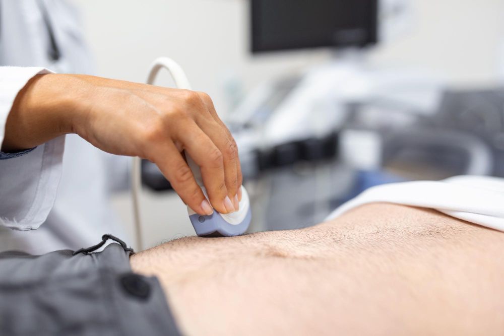 A doctor is performing an ultrasound on a patient 's stomach.