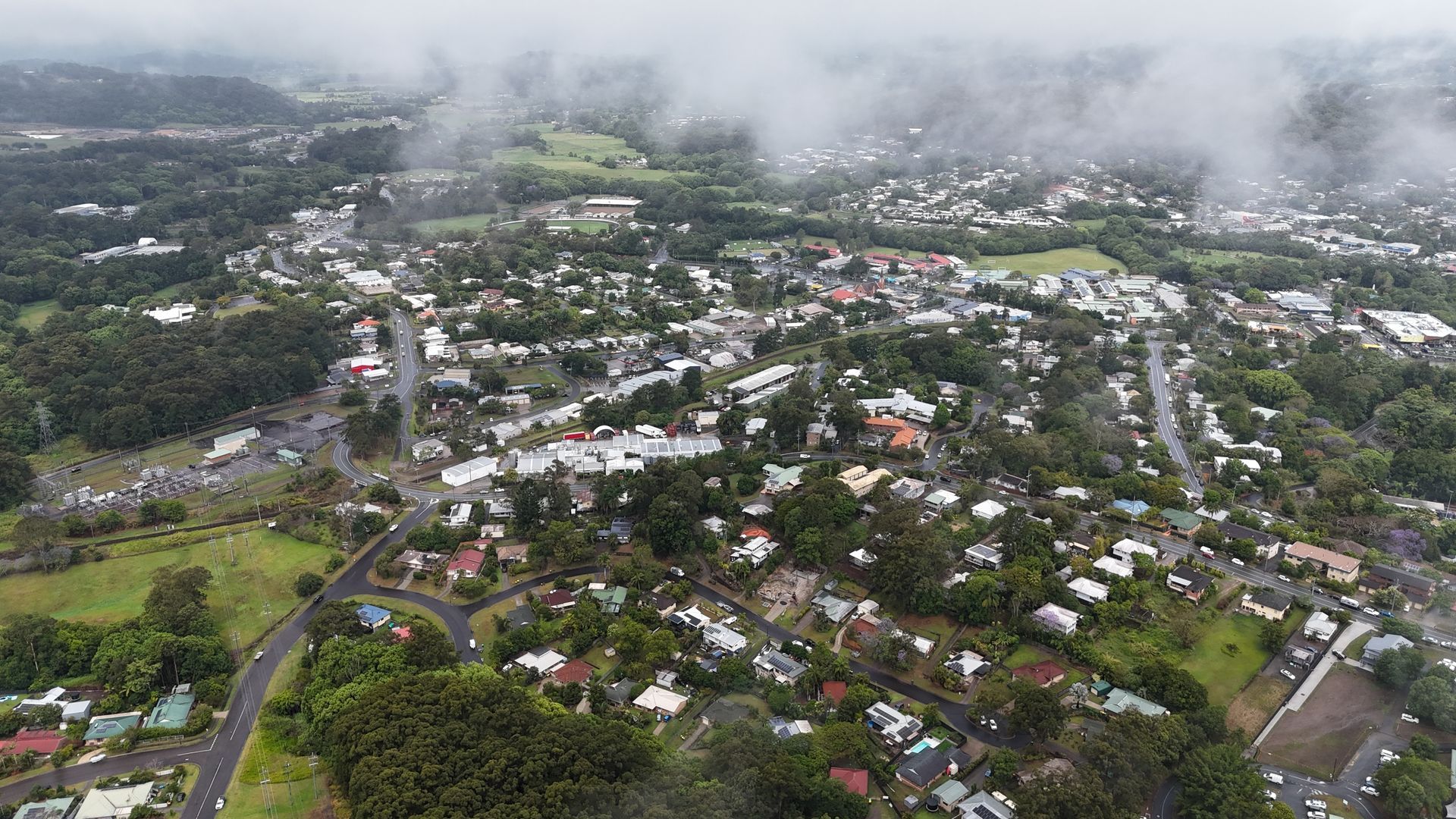 Aerial View of a Cloudy Town With Green Hills, Winding Roads — Scratchless Glass Australia in Nambour, QLD