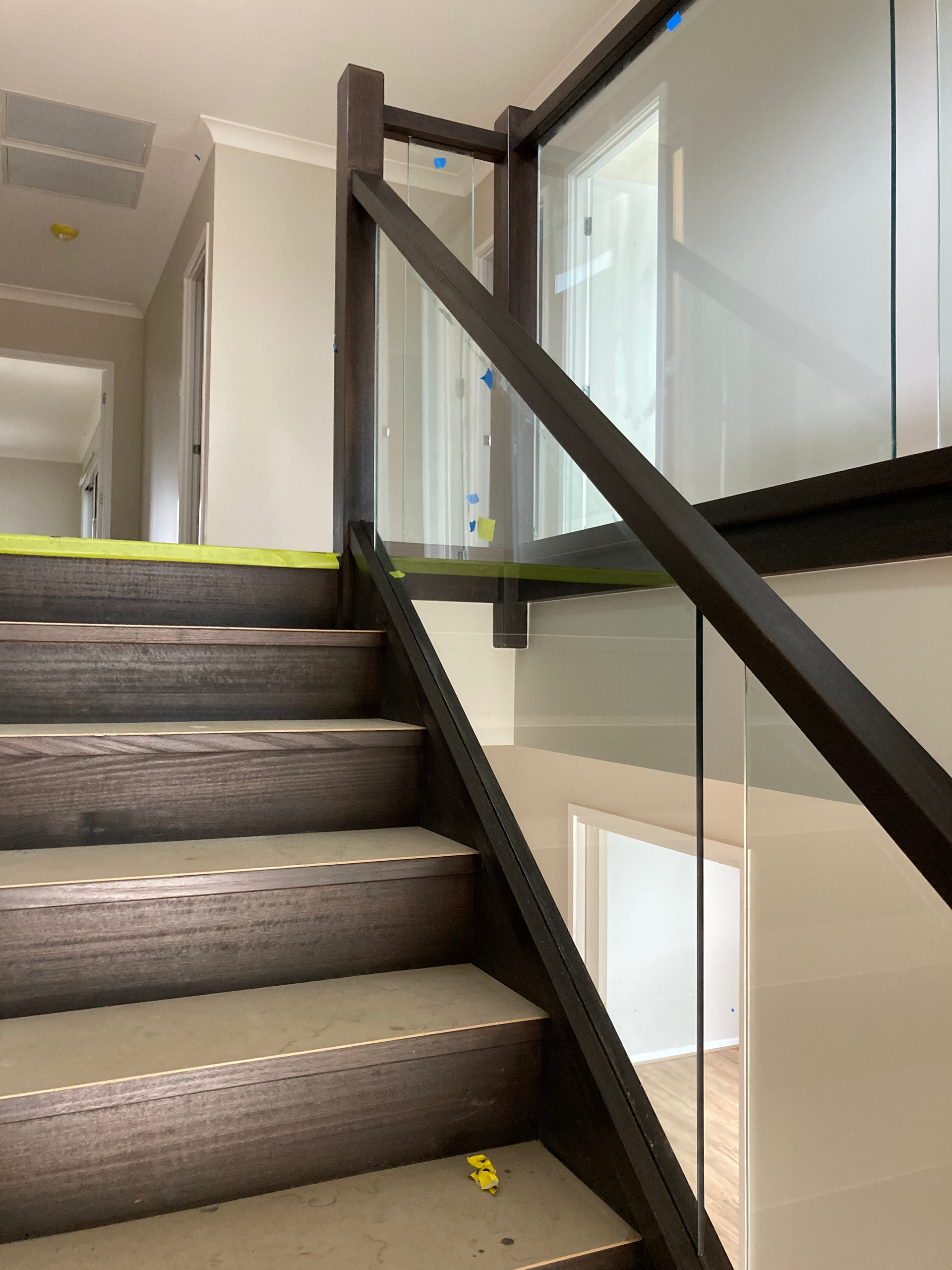 A Glass Railing With Stainless Steel Posts On A Balcony — Scratchless Glass Australia in Maroochydore, QLD