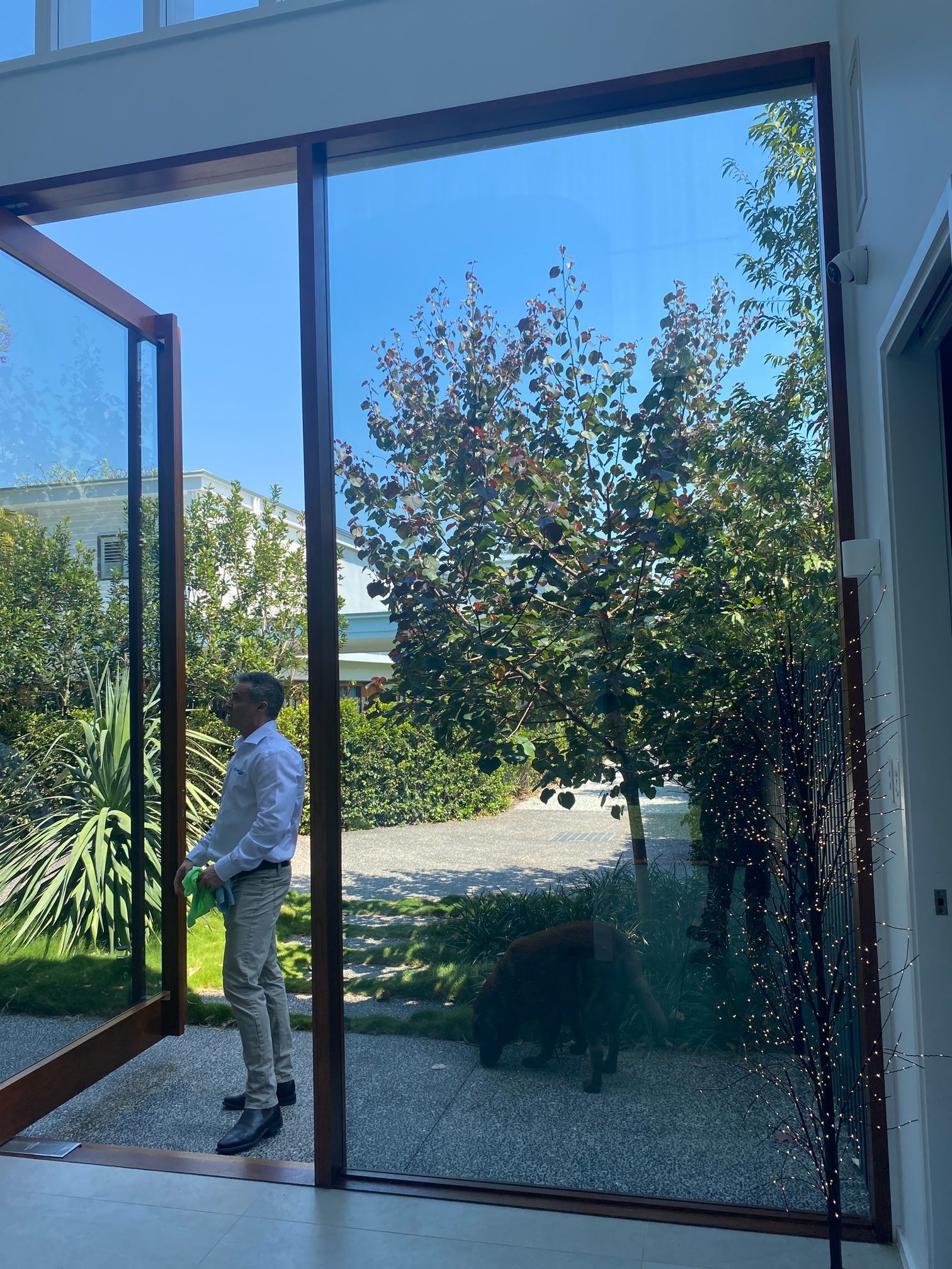A Building With A Large Glass Door And A Brick Wall — Scratchless Glass Australia in Maroochydore, QLD
