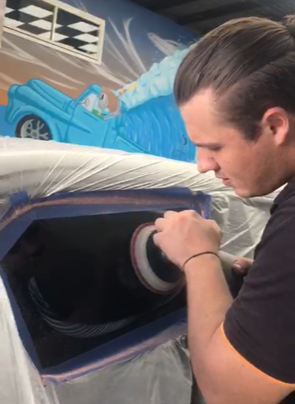 A Person Is Cleaning The Windshield Of A Car With A Towel — Scratchless Glass Australia in Maroochydore, QLD