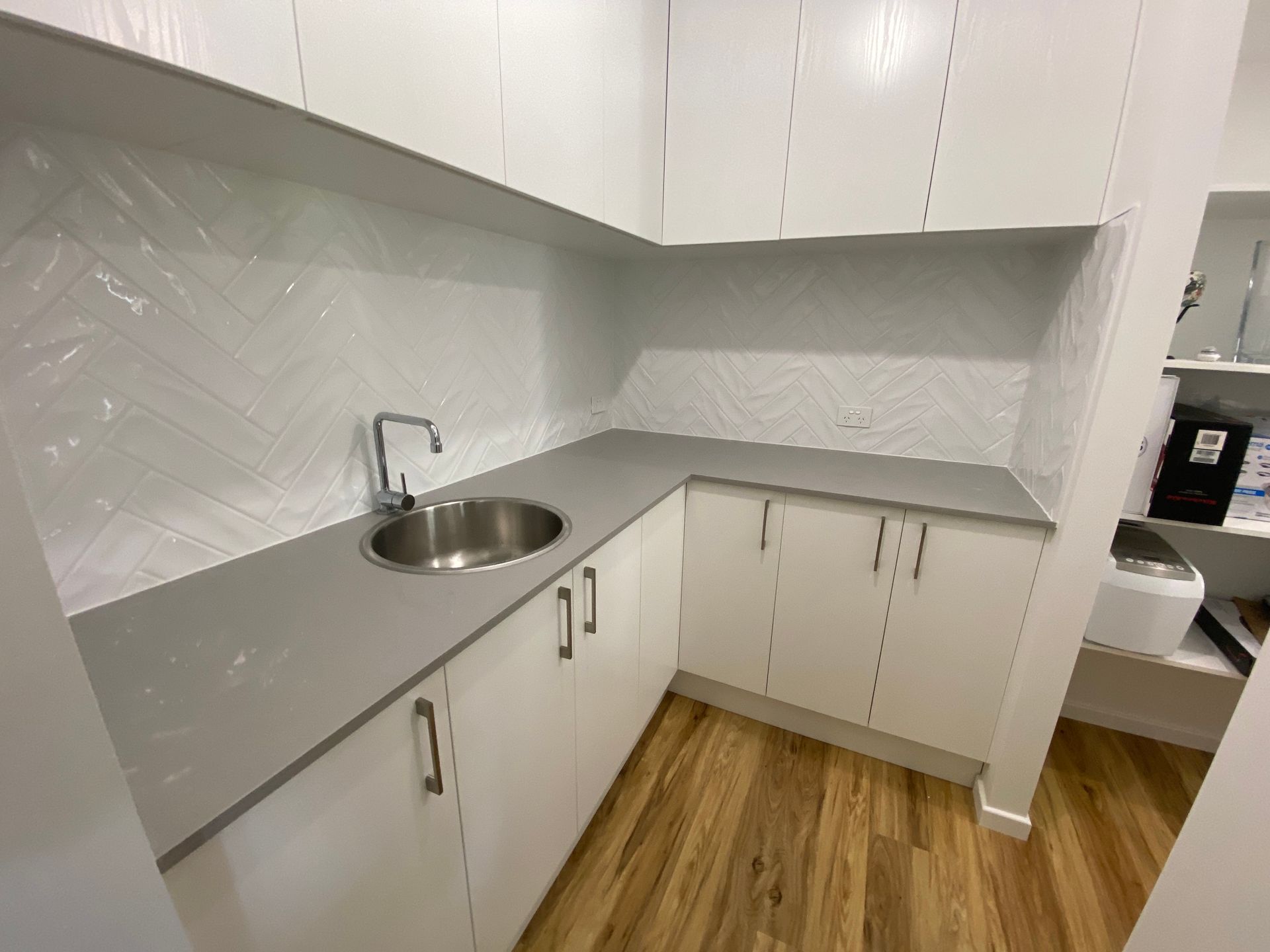 A Kitchen With Granite Counter Tops And Stainless Steel Appliances — Scratchless Glass Australia in Maroochydore, QLD