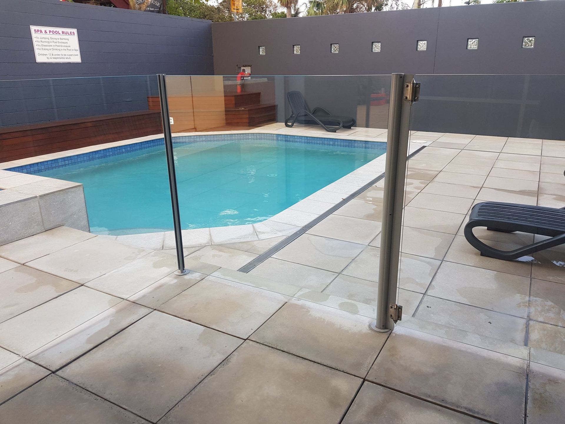 A Large Swimming Pool With Stairs Leading To It — Scratchless Glass Australia in Maroochydore, QLD