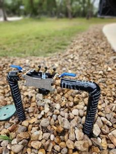 A hose is sitting on top of a pile of rocks.