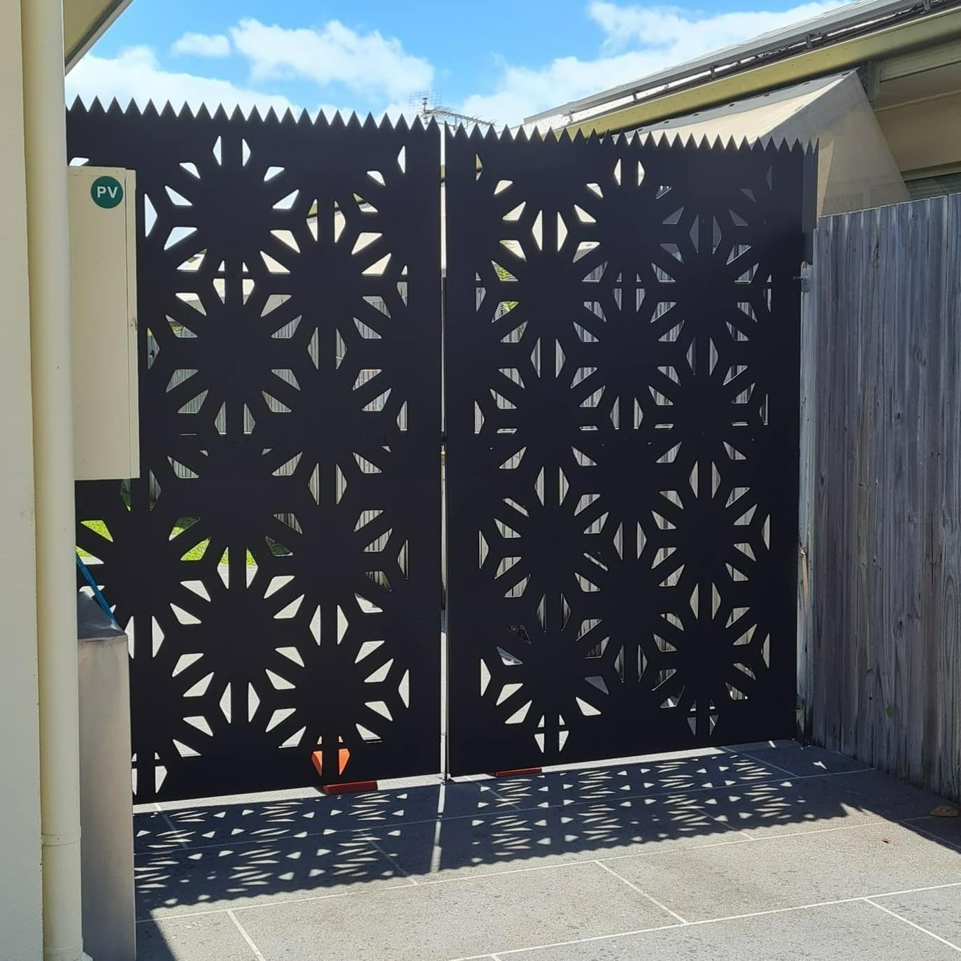 A Black Gate With A Pattern Of Circles On It — Bigdog Welding and Fabrication Pty Ltd In Currajong, QLD