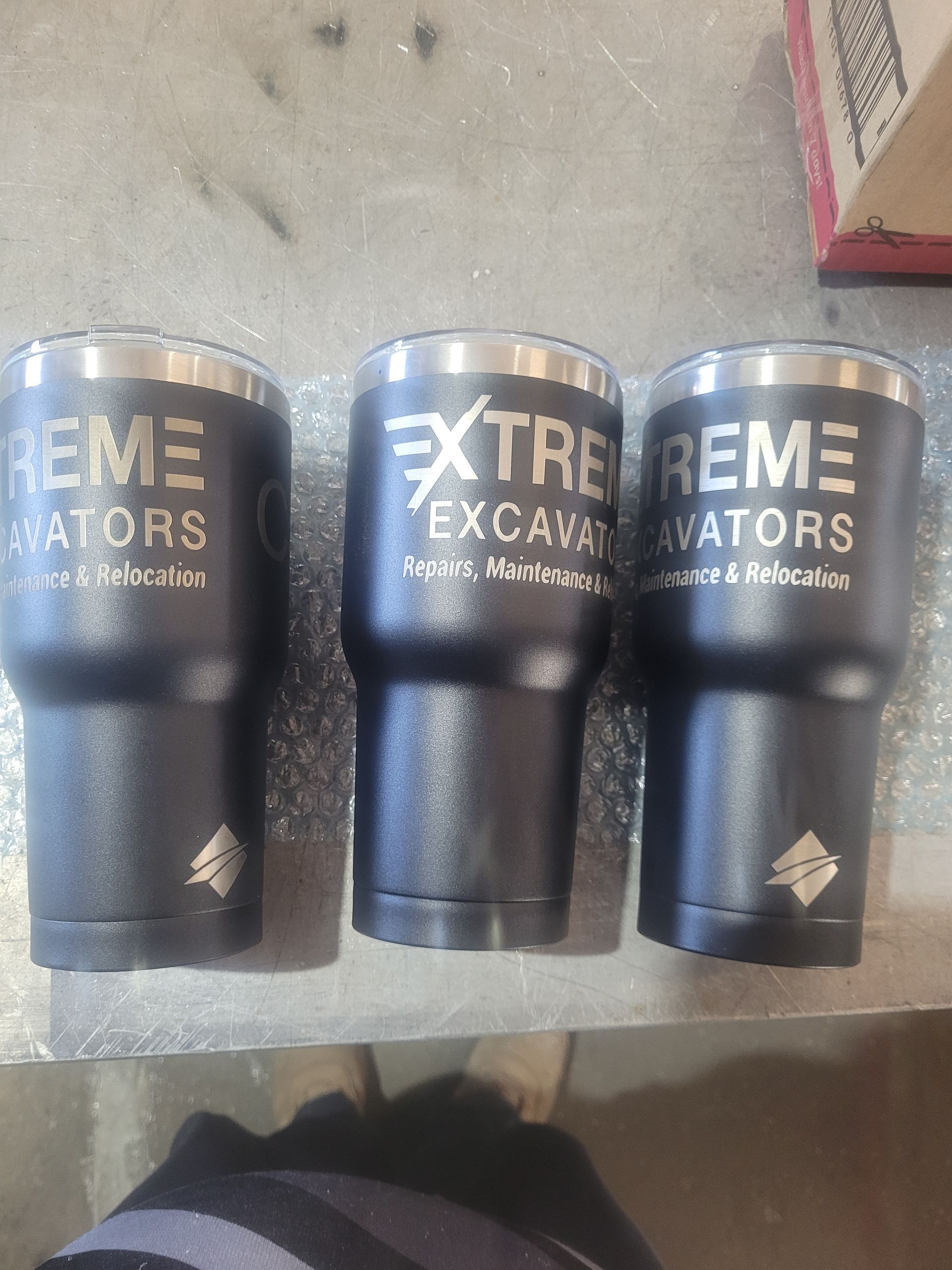 Three Black Tumblers With The Words Extreme Excavators — Bigdog Welding and Fabrication Pty Ltd In Currajong, QLD