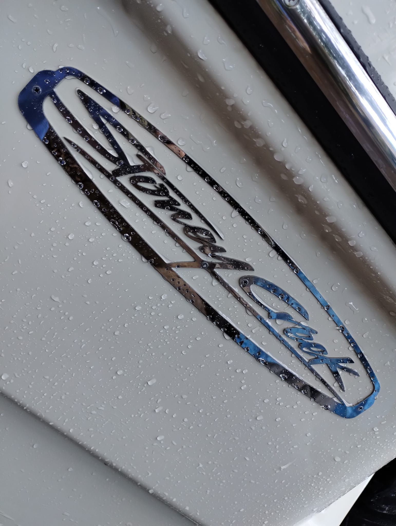 A Man In An Orange Jacket Is Welding A Metal Pipe — Bigdog Welding and Fabrication Pty Ltd In Currajong, QLD