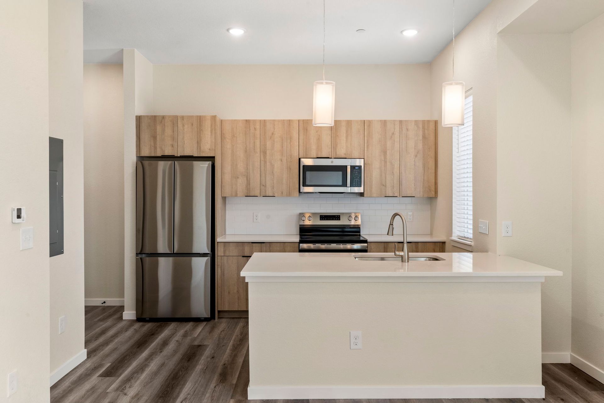 A room with a table and chairs and a television on the wall.