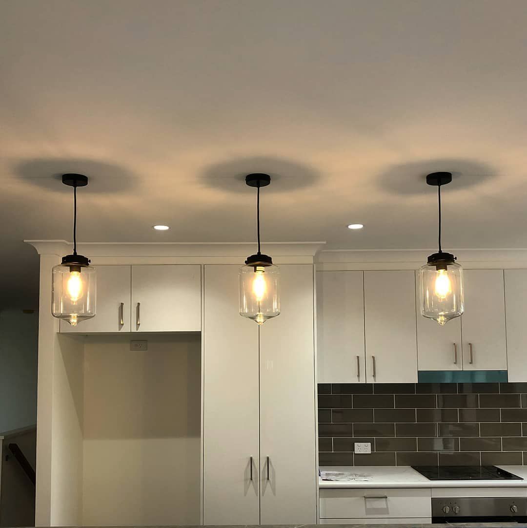 A Kitchen With Three Pendant Lights Hanging From the Ceiling — Brightway Electrical in Lennox Head, NSW