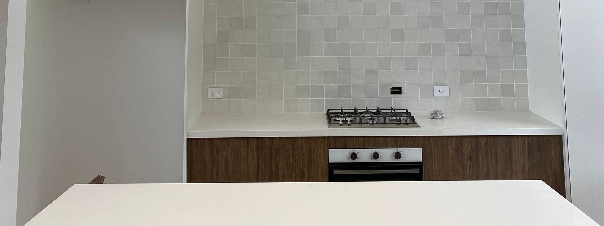 A Kitchen With A Stove Top Oven And A White Counter Top — Brightway Electrical in Lismore, NSW