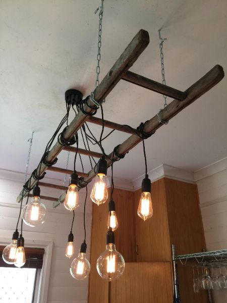 A Wooden Ladder With Lights Hanging From It — Brightway Electrical in Bangalow, NSW