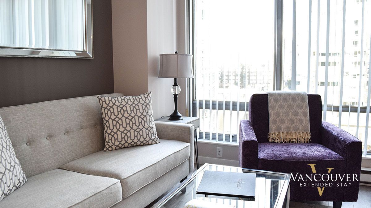 Sofa pillow with a line design on top of a sofa next to a lamp