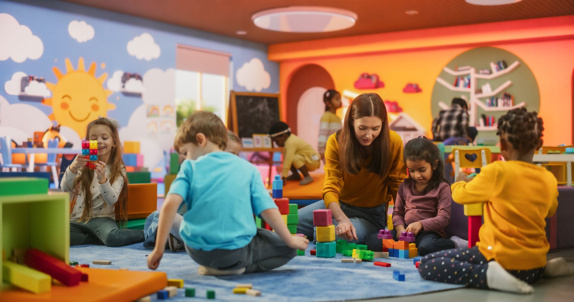 Children engaging in hands-on learning with building blocks in a preschool classroom.