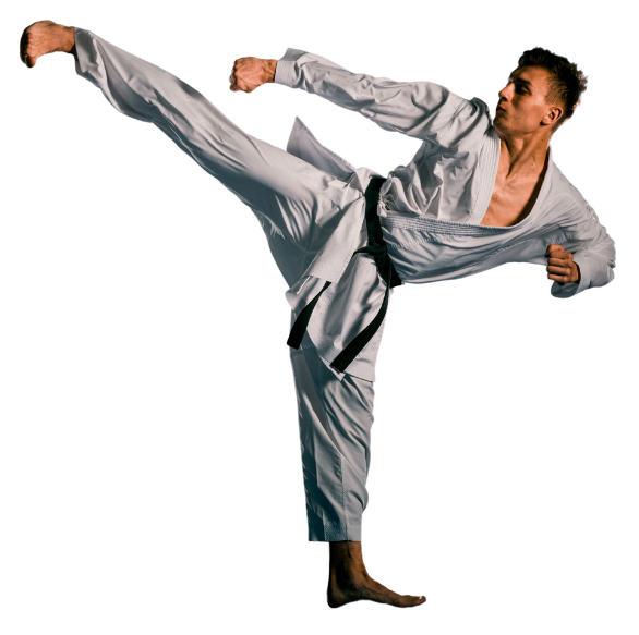 A man in a karate uniform is kicking in the air.