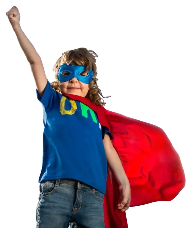 A young boy wearing a superhero cape and mask