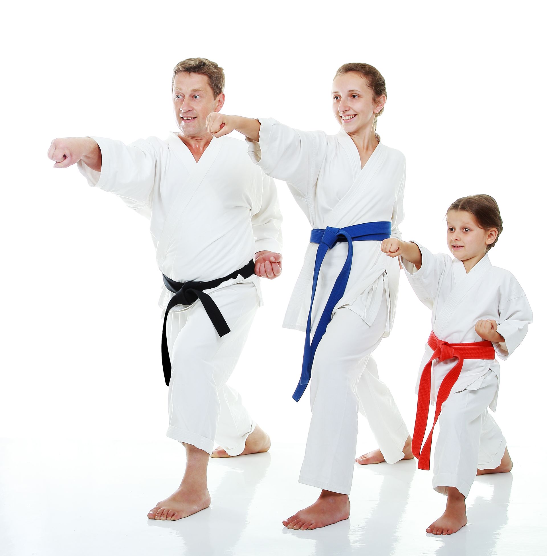 A man a woman and a child are wearing karate uniforms