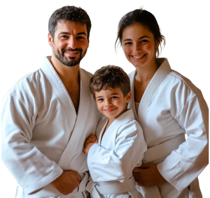 A man is holding two little girls in karate uniforms