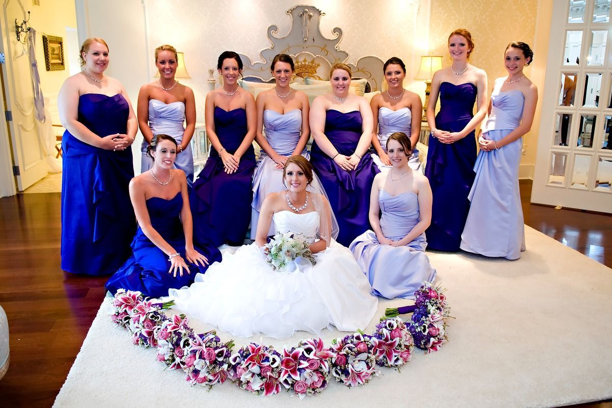 A bride and her bridesmaids are posing for a picture