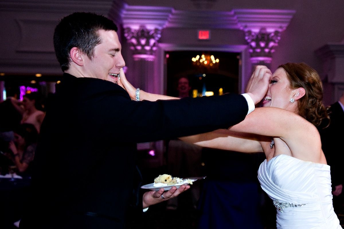 A bride and groom are dancing at their wedding reception.