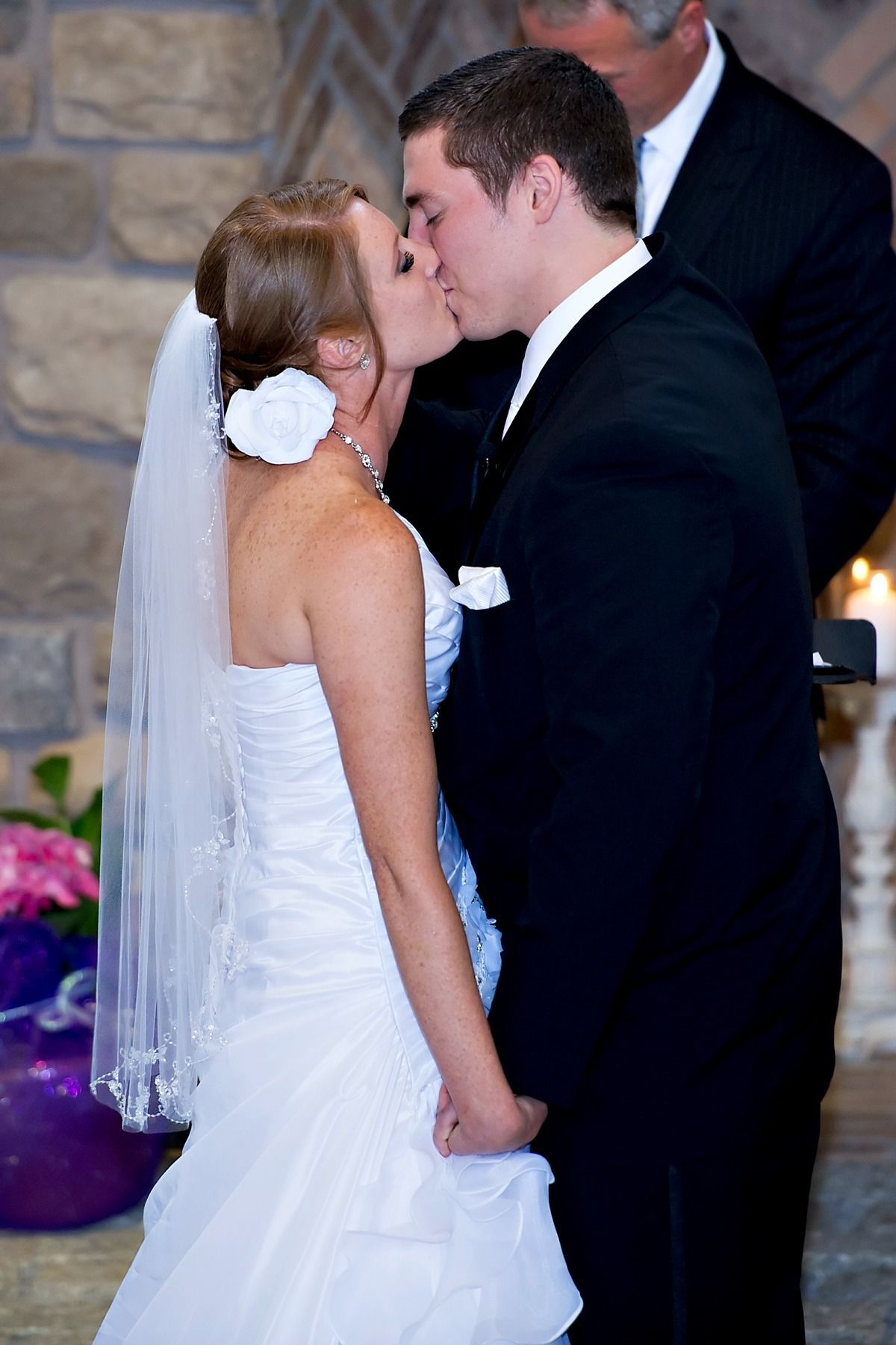 A bride and groom kissing at their wedding ceremony