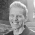 A man is smiling in a black and white photo