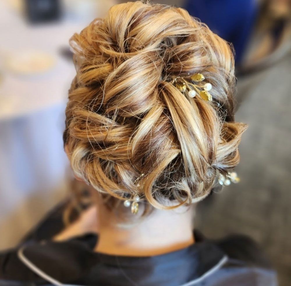 The woman is wearing a white off the shoulder top