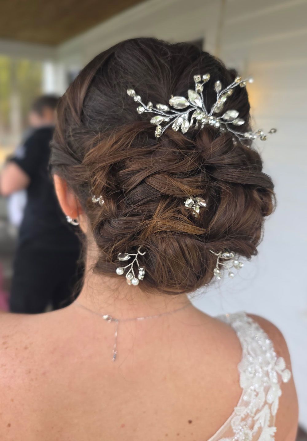 A close up of a woman 's face with a plant in the background