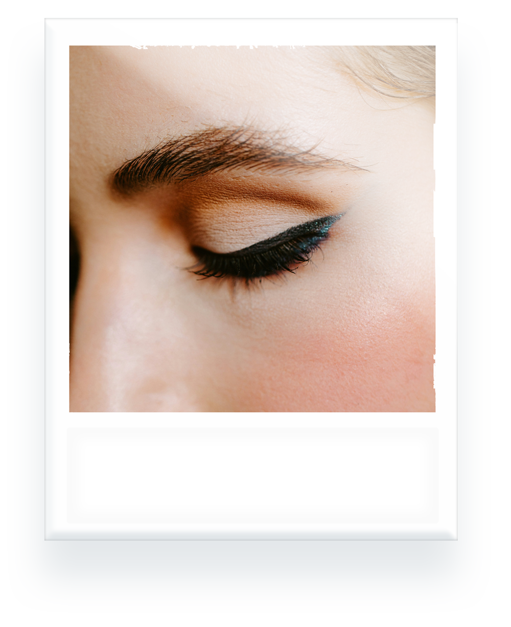 A close up of a woman 's eye with eyeliner