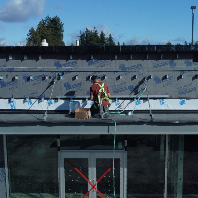 Aurora Roofing Worker Installing Metal Cladding