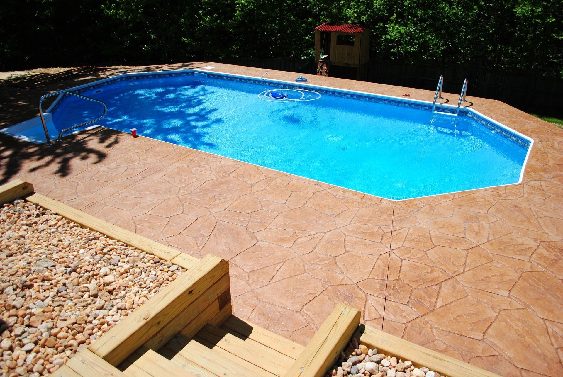 A large swimming pool with stairs leading to it