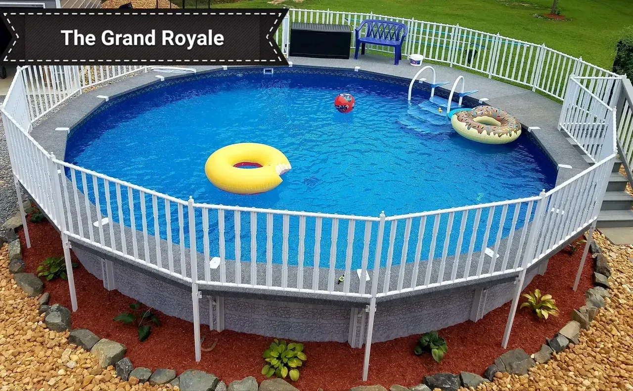 A large swimming pool with a white fence around it