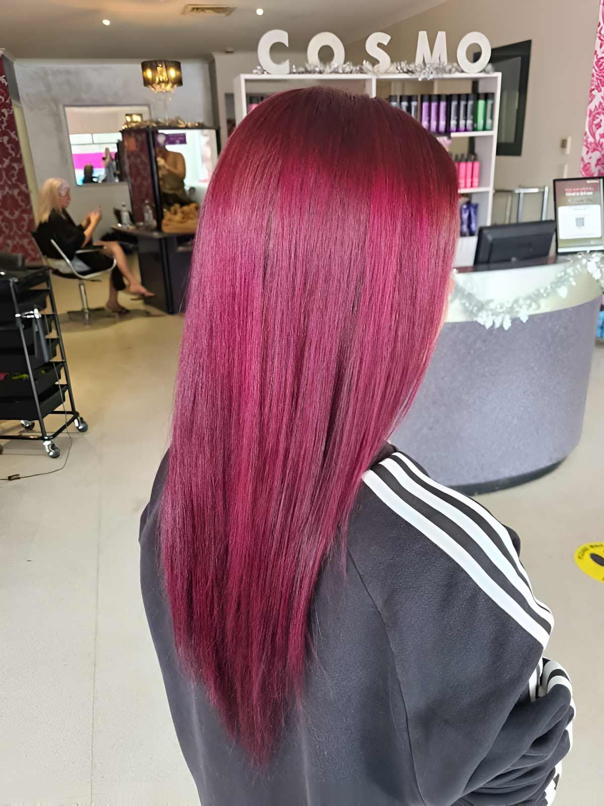 A Woman With Red Hair is Sitting in a Cosmo Salon — Cosmo Hair & Beauty In Nambour, QLD