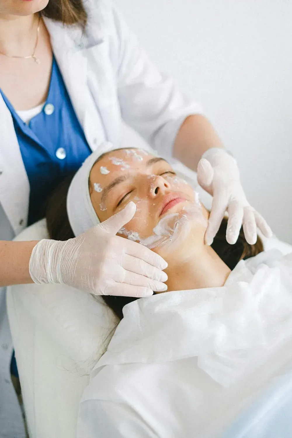 A Woman is Getting a Facial Treatment at a Beauty Salon — Cosmo Hair & Beauty In Nambour, QLD